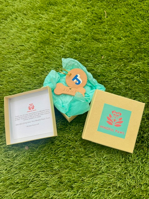 Product packaging with a card and decorative item on a grassy background